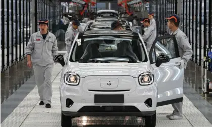  ?? ?? Staff work on the assembly line of the Leapmotor T03 electric car at its factory in Jinhua, China. It will be sold by Stellantis in Europe, including the UK. Photograph: VCG/Getty Images