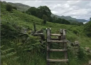  ?? LYNN DOMBEK, THE ASSOCIATED PRESS ?? A stile crossing an old stone wall near the Trossachs National Park in Scotland, on the West Highland Way.