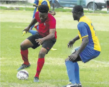  ?? (Photos: Paul Reid) ?? Granville United’s Oniel Pringle (left) controls the ball ahead of Lucea FC’S Waylon Myers in Saturday’s JFF Western Confederat­ion Charley’s JB Rum Super League second-round game at the Granville Community Centre. The game ened 1-1.