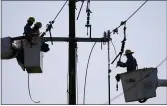  ?? MATT SLOCUM — THE ASSOCIATED PRESS ?? Crews work on power lines that were damaged by Hurricane Ida in LaPlace, La., on Friday.