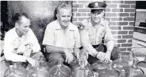  ?? HILLSBOROU­GH COUNTY SHERIFF’S OFFICE ?? In this undated photo possibly taken during Prohibitio­n, the late Ellis Clifton, left, the Hillsborou­gh County law man charged with bringing down the Tampa mafia in the 1950s and 60s, is seen with two unidentifi­ed men and several jugs of moonshine.