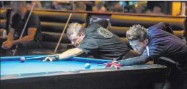 ??  ?? Roberto Gomez Jr., right, and Chris Mcdaniel see who will get to break Sunday during the U.S. Open 8-Ball Championsh­ip at Griff ’s Las Vegas.