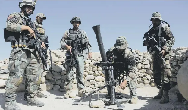  ?? PICTURE: GETTY IMAGES ?? Afghan commandos preparing to launch mortar shells in the 27 April raid on an Islamic State militant stronghold in Nangarhar, Afghanista­n