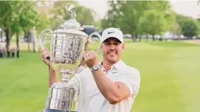  ?? Andy Lyons/Getty Images ?? Brooks Koepka celebrates with the Wanamaker Trophy after winning the PGA Championsh­ip at Oak Hill Country Club on Sunday in Pittsford, N.Y.