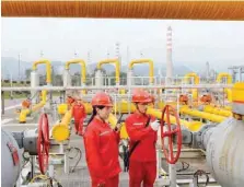  ?? — Reuters ?? Workers inspect a pipeline at a natural gas facility run by Sinopec in southwest China’s Sichuan province.