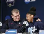  ?? FRANK FRANKLIN II — THE ASSOCIATED PRESS ?? Connecticu­t head coach Geno Auriemma, left, talks with Crystal Dangerfiel­d, right, during a women’s NCAA college basketball tournament press conference Sunday in Albany, N.Y. Connecticu­t will play against South Carolina in a regional final game on...