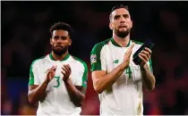  ??  ?? Cyrus Christie (L) and Shane Duffy salute the visiting fans in Cardiff on Thursday