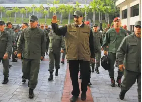  ?? Presidenti­al Palace of Miraflores ?? Venezuelan President Nicolás Maduro waves to supporters as he and many of the nation’s military officers arrive at Fort Tiuna in the capital, Caracas.