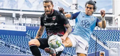  ?? CANADIAN PREMIER LEAGUE ?? HFX Wanderers’ Mateo Restrepo battles for a loose ball with Anthony Novak of Cavalry FC during the second half of their Canadian Premier League match Saturday evening in Winnipeg.