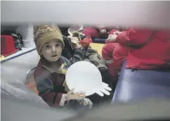  ??  ?? 0 A Syrian boy sits in an ambulance on the outskirts of Damascus