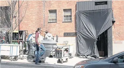  ?? KELSEY WILSON TORONTO STAR FILE PHOTO ?? Crew members work at Church and Front Sts. during the filming of the Netflix series, Spinning Out. Netflix says it is on track to “significan­tly exceed” the $500 million it promised to spend on Canadian production­s over five years.