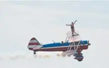  ??  ?? Wing walker Ashley Battles performs with pilot Greg Shelton during the 2013 Rocky Mountain Airshow at Rocky Mountain Metropolit­an Airport in Broomfield.