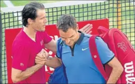  ?? AFP ?? Roger Federer is comforted by Tommy Haas after the Swiss great lost the roundof16 match.