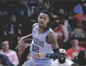  ?? MICHAEL WYKE/AP ?? MEMPHIS GRIZZLIES GUARD JA MORANT reacts after sinking a three point shot against the Houston Rockets during the first half of an NBA basketball game on March 1, 2023, in Houston.