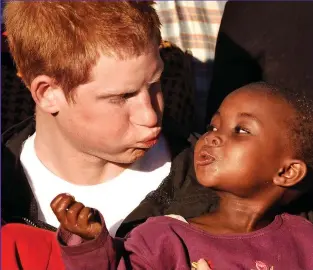  ??  ?? Blowing bubbles: Prince Harry makes faces with Lintle at a children’s home on his return to Lesotho in 2006 to launch his charity Sentebale