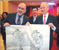  ?? ZHAO HUANXIN / CHINA DAILY ?? Ambassador Cui Tiankai displays a New Year’s drawing with an embassy guest. Spring Festival falls on Friday.