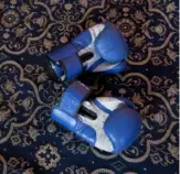  ?? Associated Press ?? Boxing gloves of Eyed Akeel Khan are on the floor of the room where he practices in Srinagar, in Indian controlled Kashmir.