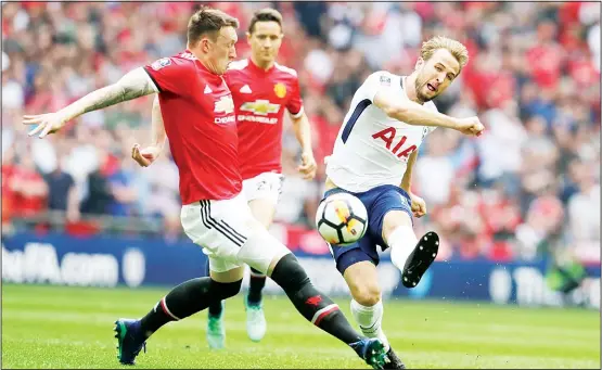  ??  ?? Tottenham’s Harry Kane shoots the ball past Manchester United’s Phil Jones (left), during the English FA Cup semifinal soccer match between Manchester United and Tottenham Hotspur at
Wembley Stadium in London on April 21. (AP)
