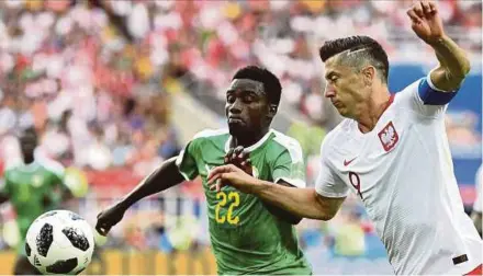  ?? AFP PIC ?? Poland’s Robert Lewandowsk­i (right) and Senegal’s Moussa Wague battle for the ball at the Spartak Stadium on Tuesday.