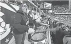  ?? DORAL CHENOWETH/THE COLUMBUS DISPATCH ?? Heidi Tybee drums as part of the Nordecke, the Columbus Crew SC rowdy fan section, on April 2 inside Lower.com Field.
Scarpitti said.