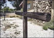  ?? ASSOCIATED PRESS ?? Burned crosses stand last week outside the Sylmar Christian Fellowship Church. Three wooden crosses outside the small church were found burned early June 30.