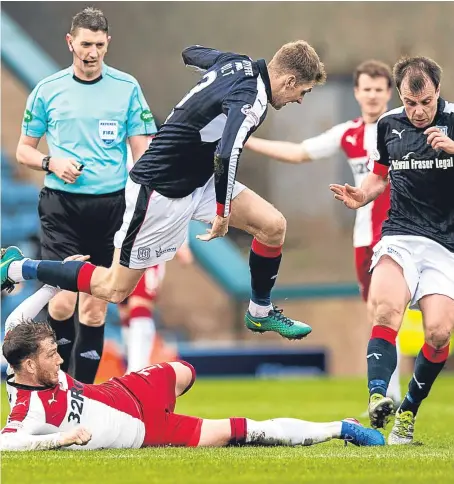  ??  ?? Rangers striker Joe Garner goes to ground in a bid to get the better of Kevin Holt and Paul McGowan.