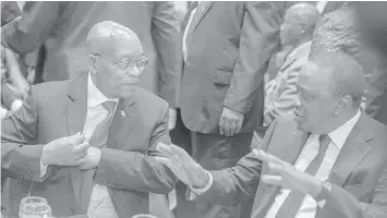  ?? AGENCE FRANCE PRESSE ?? South African ruling party African National Congress former President and current South African President Jacob Zuma talks with Kenyan President Uhuru Kenyatta (R) at the Gala dinner on the eve of the 106th ANC birth Anniversar­y Celebratio­ns on January...