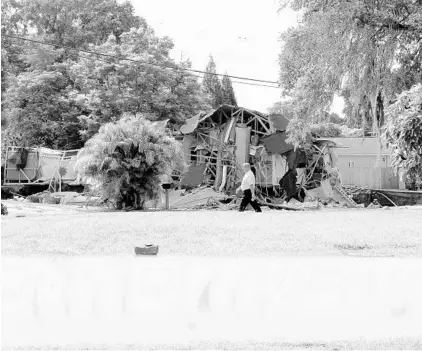  ?? ALESSANDRA DA PRA/ASSOCIATED PRESS ?? Debris is strewn at the site of a partially collapsed home Friday in Land O’Lakes. A sinkhole — that started out the size of a small swimming pool and continued to expand —destroyed two homes and forced the evacuation of nine more in the area.