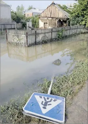  ?? Mcclatchy Newspapers ?? A flooded street is seen n the town of Krymsk, Russia, on Sunday. Flash floods caused by torrential rain have swept southern Russia’s Krasnodar region, killing at least 171 people.