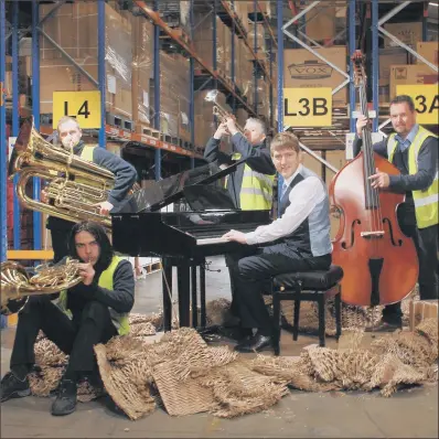  ?? PICTURE: RUSSELL SACH. ?? GROUP EFFORT: Gear4music chief executive Andrew Wass ( on piano) praised the York- based online retailer’s ‘ amazing staff’.