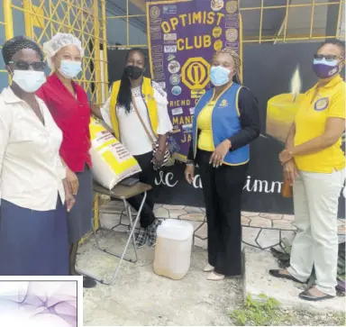  ?? (Photo: Kasey Williams) ?? Candle in the Dark caregiver Velma Fedricks and Administra­tive Assistant Racquel Young receive two items from Optimist Club of Mandeville members Merv Hanson, President Chioma Dinnallfor­bes and Whylma Spence.