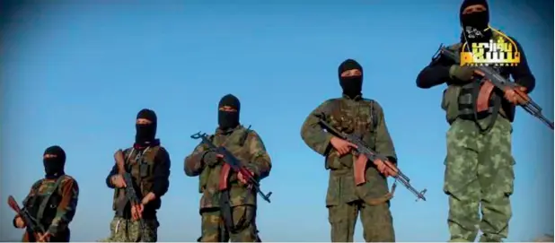  ?? —AP ?? Fighters from the Turkistan Islamic Party hold their weapons at an unknown place in Syria. Many don’t speak Arabic and their role in Syria is little known to the outside world.