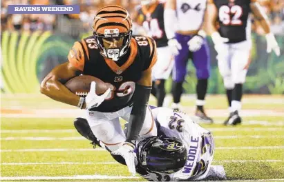  ?? FRANK VICTORES/ASSOCIATED PRESS ?? Wide receiver Tyler Boyd, being tackled Thursday by Ravens safety Eric Weddle, helped the Bengals compile 265 passing yards and four passing touchdowns Sept. 13 against the Ravens. Boyd led Cincinnati with six catches for 91 yards and a touchdown.