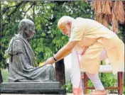  ?? PTI ?? PM Narendra Modi offers flowers to a statue of Mahatma Gandhi at the Sabarmati ashram in Ahmedabad on Thursday.