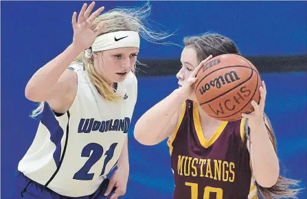  ?? DAVID BEBEE WATERLOO REGION RECORD ?? The Woodland Christian Cavaliers’ Kate Drost, left, pressures the Monsignor Doyle Mustangs’ Avery Carr during their District 8 senior girls’ basketball semifinal game at Woodland on Wednesday. Kate Drost had 13 points and her sister Mae Drost poured in a game-high 18.