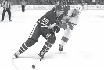  ?? CP PHOTO ?? William Nylander of the Toronto Maple Leafs pulls away from Detroit Red Wings defenceman Niklas Kronwall during Thursday’s game in Toronto.