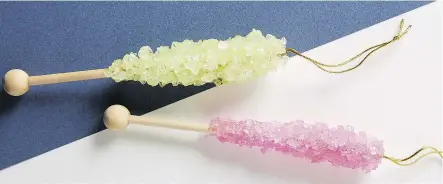  ?? ANTHROPOLO­GIE ?? Old-fashioned rock candy was the inspiratio­n for Anthropolo­gie’s pink and lime glass and wood ornaments.