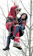  ?? FRANK GUNN/THE CANADIAN PRESS ?? A woman is rescued from a downtown Toronto crane early Wednesday. Some streets in the downtown core were closed as dozens of constructi­on workers and commuters gazed skyward to watch police and firefighte­rs try to rescue a woman who got stuck atop a...