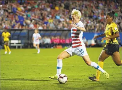  ?? Cooper Neill Getty Images ?? MEGAN RAPINOE of the United States scores a goal against Jamaica during the first half of the CONCACAF Women’s Championsh­ip semifinals Sunday in Frisco, Texas.