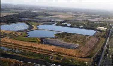  ?? TIFFANY TOMPKINS — THE BRADENTON HERALD VIA AP ?? This aerial photo taken from an airplane shows a reservoir near the old Piney Point phosphate mine, Saturday, April 3, 2021 in Bradenton, Fla. Florida Gov.
Ron DeSantis declared a state of emergency Saturday after a significan­t leak at a large pond of wastewater threatened to flood roads and burst a system that stores polluted waters. The pond where the leak was discovered is at the old Piney Point phosphate mine, sitting in a stack of phosphogyp­sum, a waste product from manufactur­ing fertilizer that is radioactiv­e.