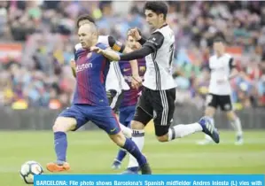  ?? — AFP ?? BARCELONA: File photo shows Barcelona’s Spanish midfielder Andres Iniesta (L) vies with Valencia’s Portuguese forward Goncalo Guedes during the Spanish league footbal match between FC Barcelona and Valencia CF at the Camp Nou stadium in Barcelona.