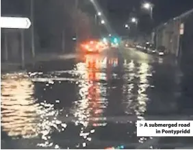  ??  ?? &gt; A submerged road in Pontypridd