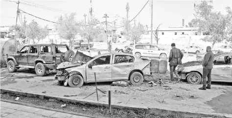  ??  ?? People inspect the damage at the site of a car bomb that killed three people in Iraq’s Mosul yesterday, the first such attack since jihadists were ousted from the city last year. There was no immediate claim of responsibi­lity for the blast. The Islamic State group, which once controlled a cross-border ‘caliphate’ home to millions of people, lost control of Mosul and the rest of its urban stronghold­s in 2017 but it has continued to wage guerilla-style attacks across Iraq. — AFP photo