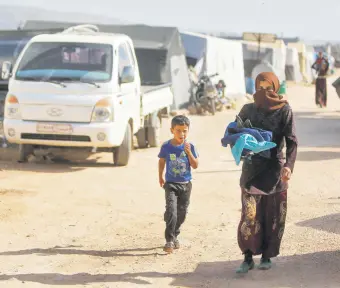  ?? ?? Displaced Syrian children return to their tents at a camp for displaced people on the outskirts of the opposition-held town of Dana, in Idlib province, Syria, April 30, 2022.