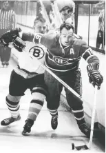  ?? GAZETTE FILES ?? Henri Richard battles along the boards with Boston Bruins' Bobby Orr at the Montreal Forum in March 1967.