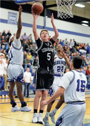  ?? GARY PORTER / FOR THE JOURNAL SENTINEL ?? Cedarburg’s Jordan Johnson goes up for a shot Friday night against Whitefish Bay. Of the 11 baskets he made, two came from three-point range. More photos at jsonline.com/preps.