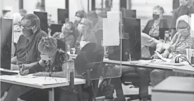  ?? THOMAS HAWTHORNE/THE REPUBLIC ?? Workers count ballots on Election Day at Maricopa County elections headquarte­rs in Phoenix.