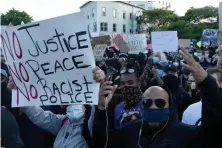  ?? JIM MICHAUD / BOSTON HERALD ?? FED UP: Thousands of protesters march in Dudley Square, heading to the State House, on Sunday evening.