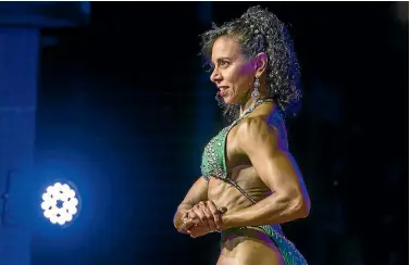  ?? PHOTOS: GRANT MATTHEW/STUFF ?? Farah Deobhakta competes in the Senior Figure 50+ section at the National Amateur Body Building Associatio­n (NABBA) Taranaki Championsh­ips held at New Plymouth Boys’ High School last weekend.