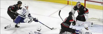  ?? CHRIS SEWARD, TNS ?? Auston Matthews who was pulled down by Carolina’s Phillip Di Giuseppe was still able to beat Cam Ward for a highlight reel goal Sunday night in Raleigh.